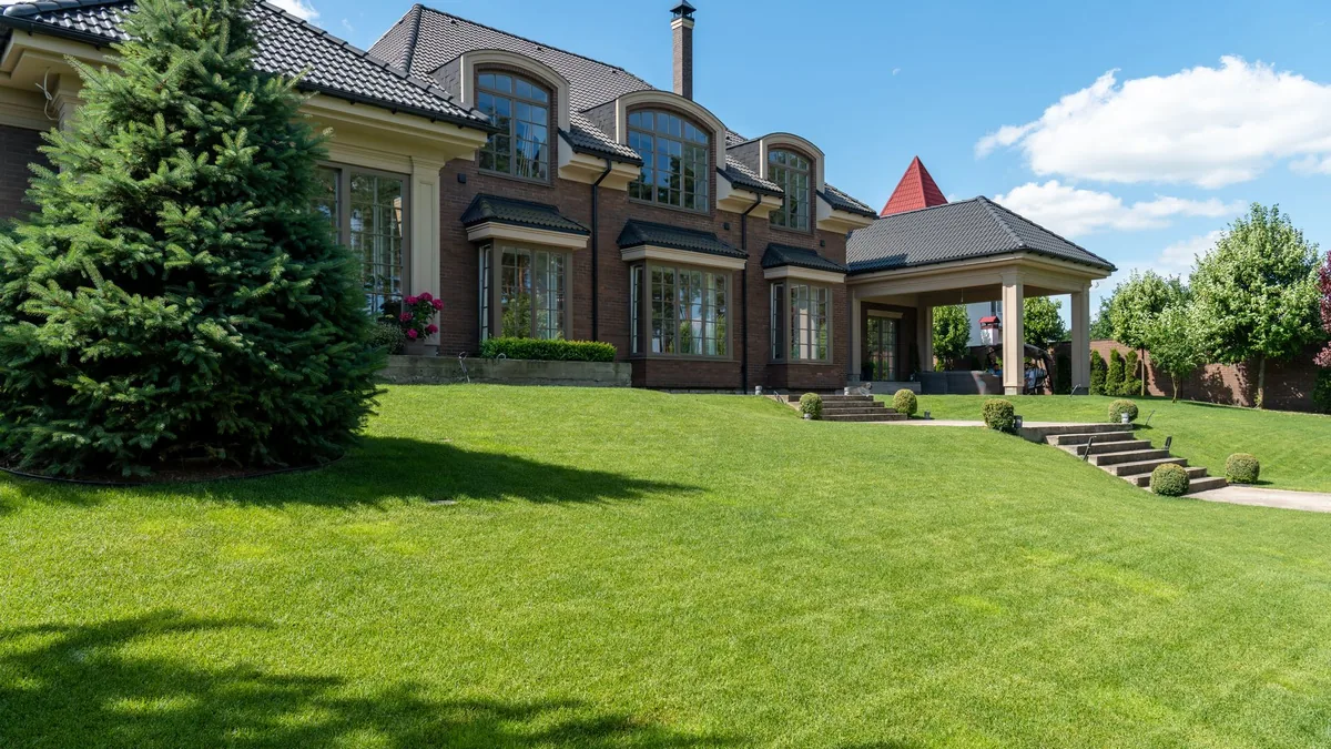 A large home in New Port Richey behind a wide, freshly mowed green lawn with clean edges